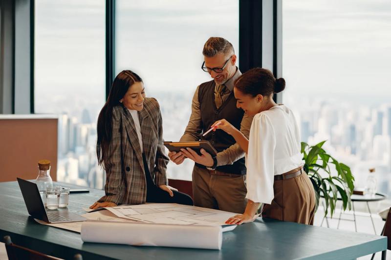 A skilled team is collaborating on a major project in a modern office with inspiring city skyline views