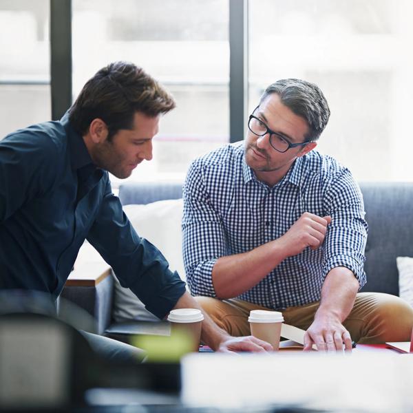 Shot of two coworkers in a meeting in an office