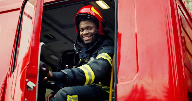 Firefighter portrait on duty. Portrait of african american Firefighter in protective suit.