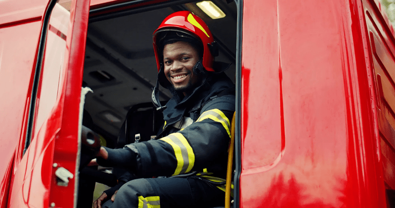 Firefighter portrait on duty. Portrait of african american Firefighter in protective suit.