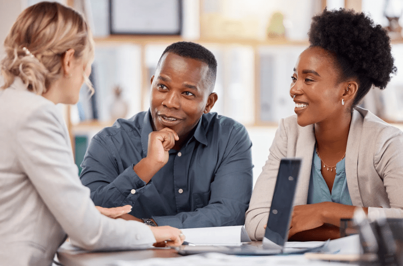 Black couple, financial advisor and investment planning meeting with bank documents and contract. Accounting, savings and budget consulting with banking management woman talking about payment.
