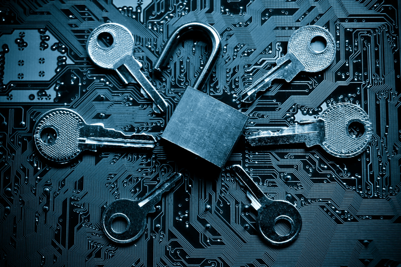 open security lock on a computer circuit board surrounded by keys / random password hacking attemp concept