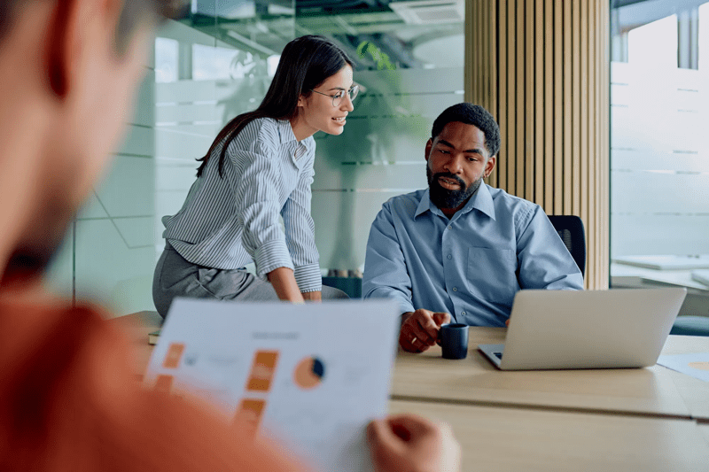 Diverse business team collaborating on project in modern office