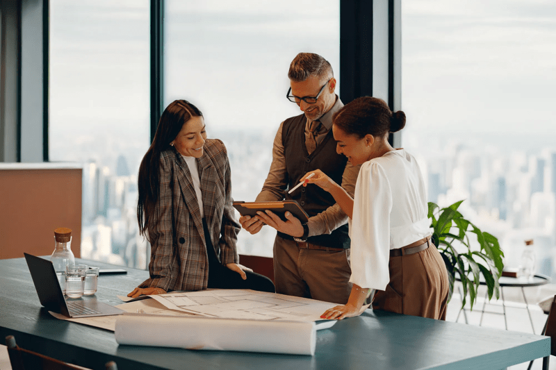 A skilled team is collaborating on a major project in a modern office with inspiring city skyline views