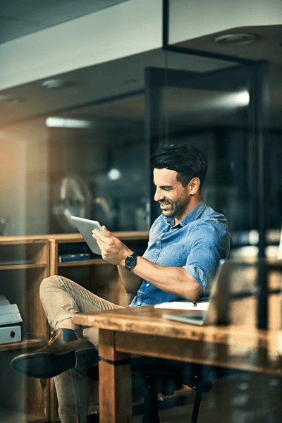 Business tools just keep getting smarter and smarter. Shot of a young businessman using a digital tablet during a late night at work