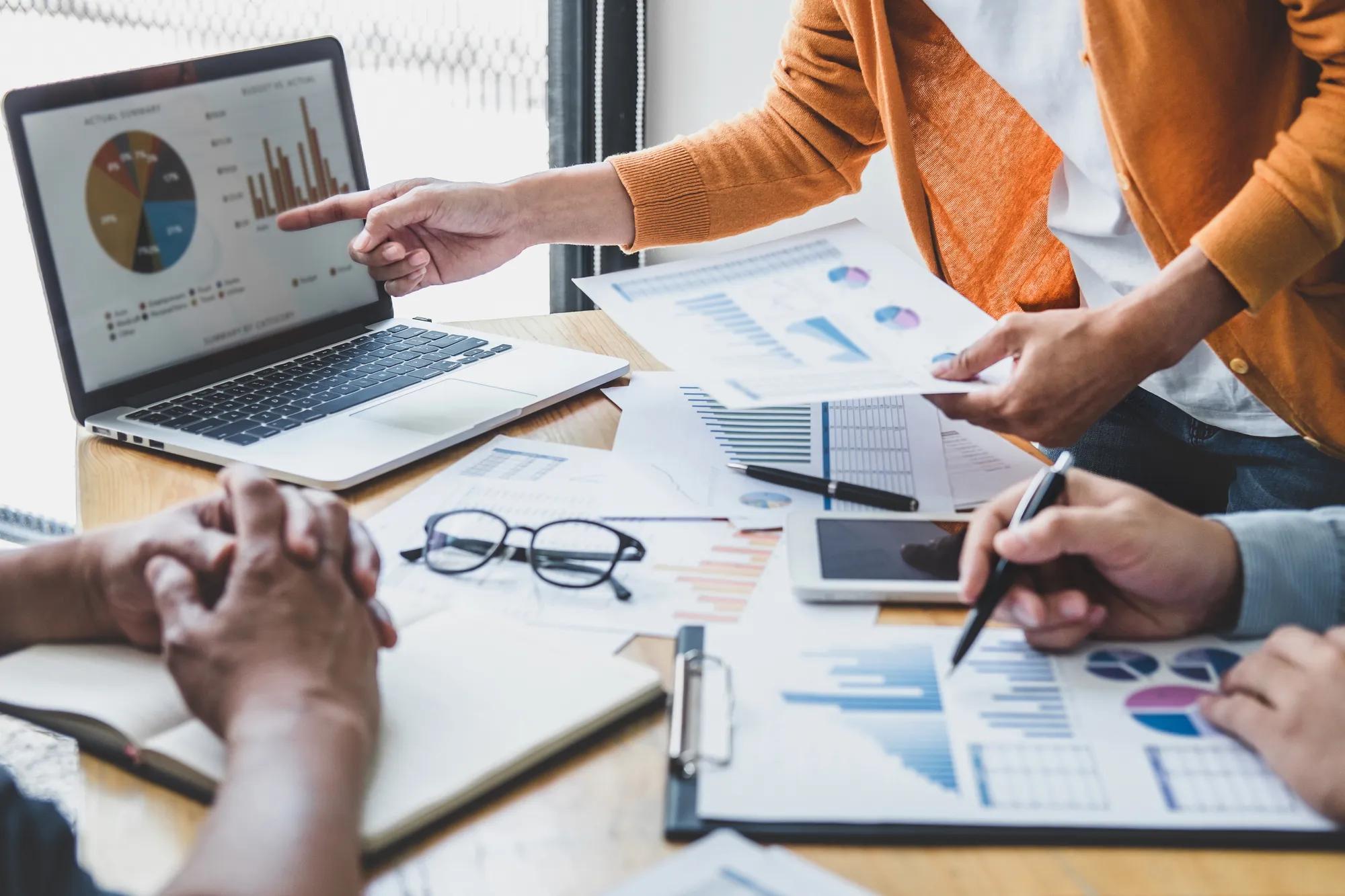 Professionals reviewing healthcare data and analytics dashboards to evaluate costs, trends, and self-funded health plan strategy decisions.