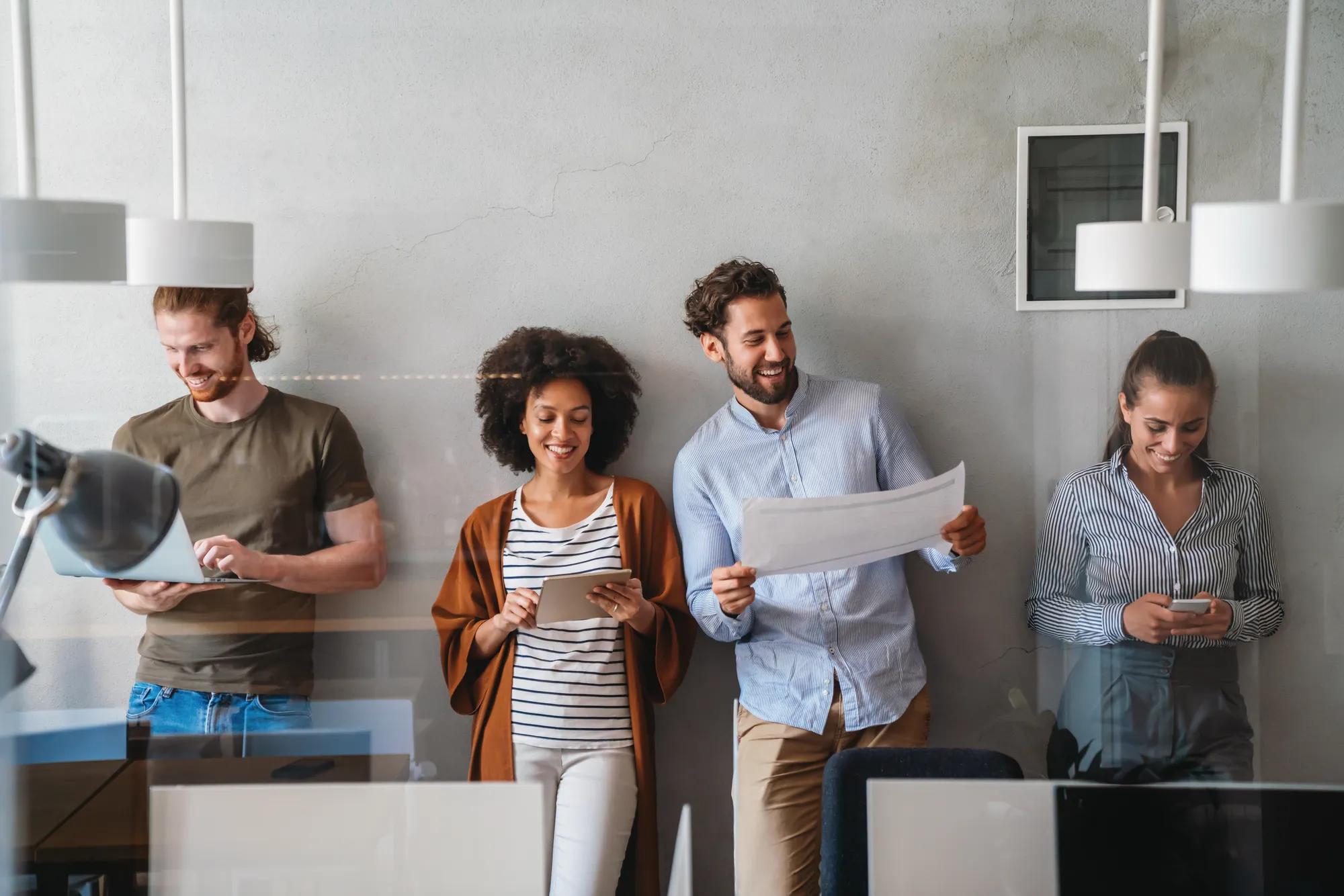 Group of young happy creative team, multicultural coworkers working in office together. Business, startup concept.