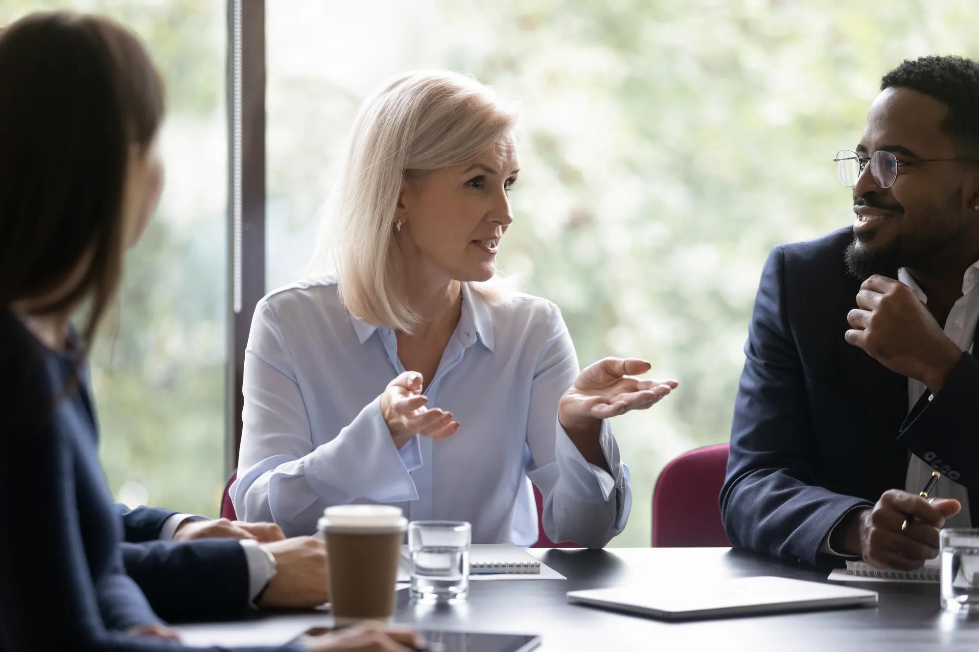 Business professionals discussing stop loss captive strategies and long-term healthcare cost management for self-funded employers.
