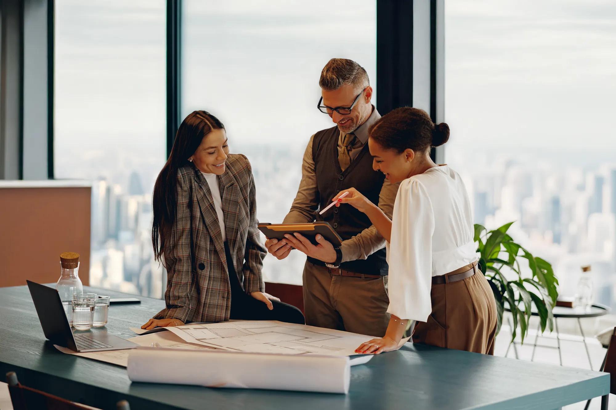 A skilled team is collaborating on a major project in a modern office with inspiring city skyline views
