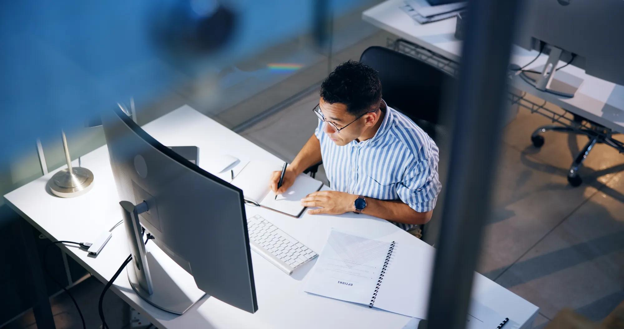 Writing, research and computer with business man in office for profit margin report, client review and advisory. Project, proposal and night with person and notebook for portfolio from above.
