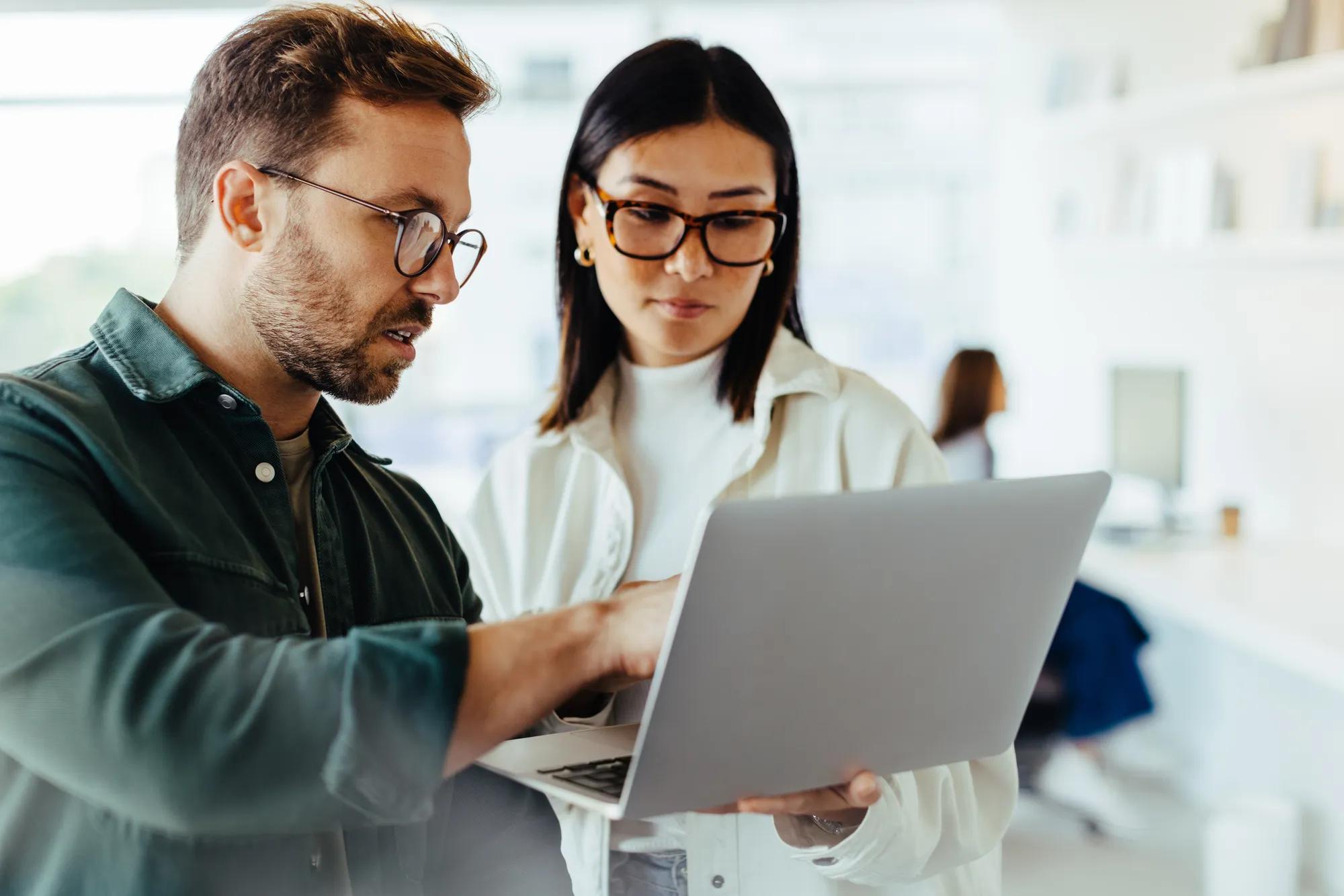 Business professionals analyzing healthcare compliance data and RxDC reporting requirements for employers in 2026