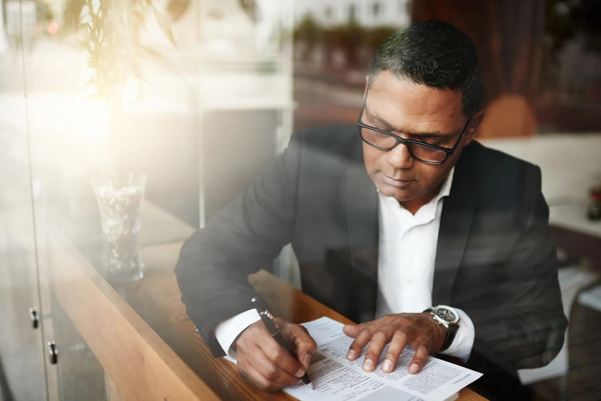 HR professional reviewing 2027 HSA contribution limits and HDHP requirements during benefits planning.