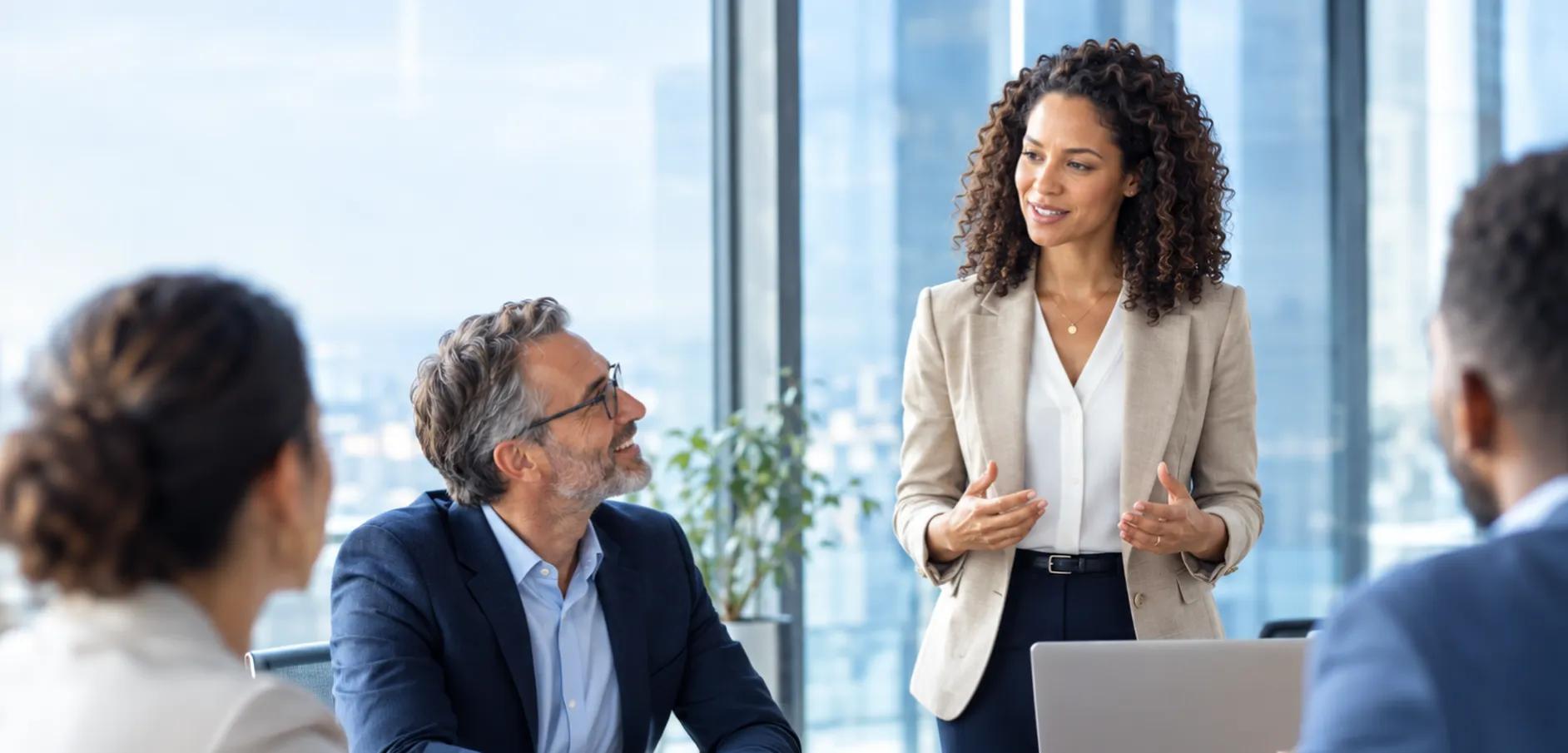 woman presenting to table of people