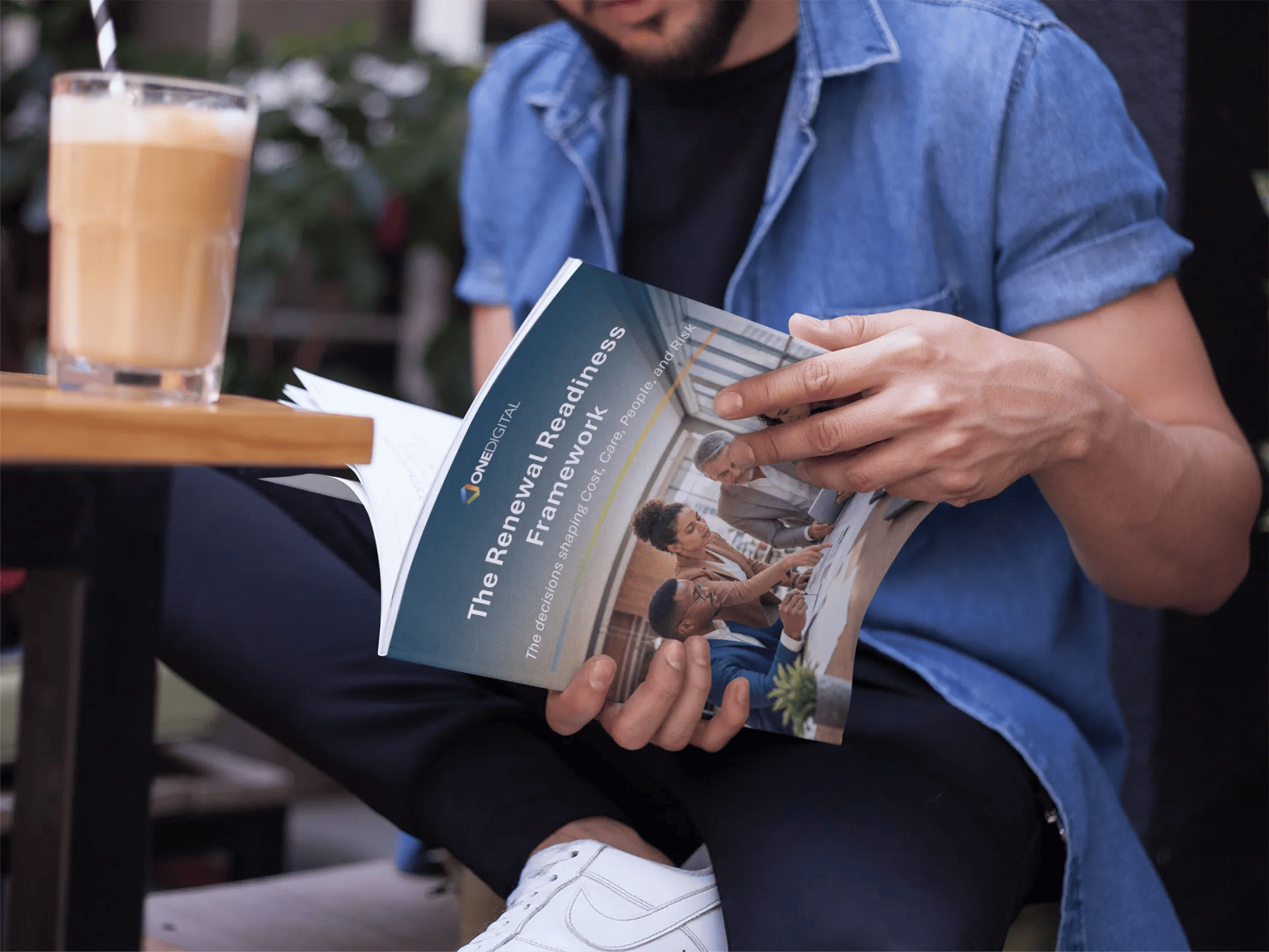 young-guy-reading-a-magazine-while-drinking-a-smoothie-in-a-cafe-outdoors-mockupa14456