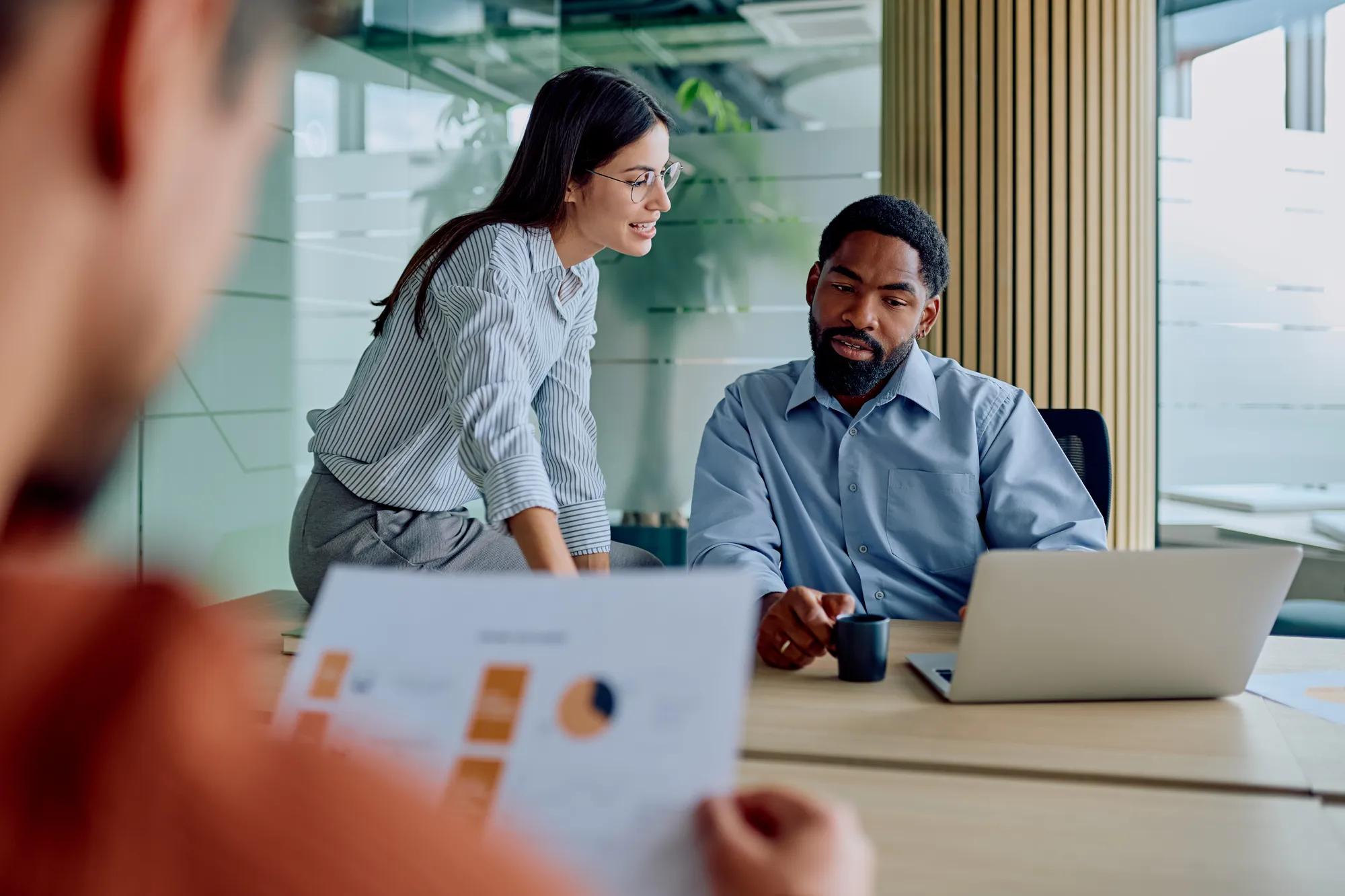 Diverse business team collaborating on project in modern office