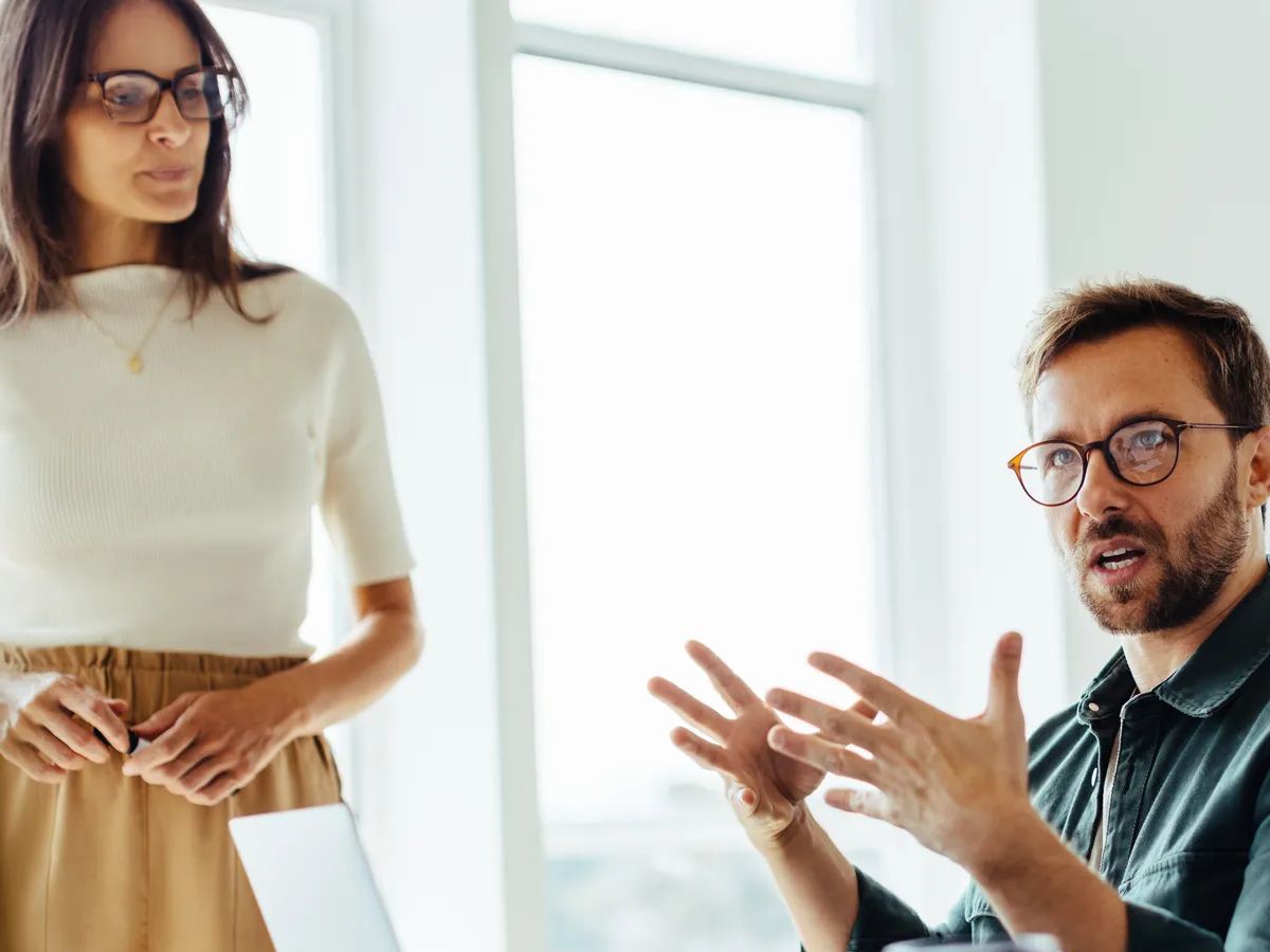 Business man discussing with his team during a meeting in an office. Group of business professionals planning an upcoming project in an office.