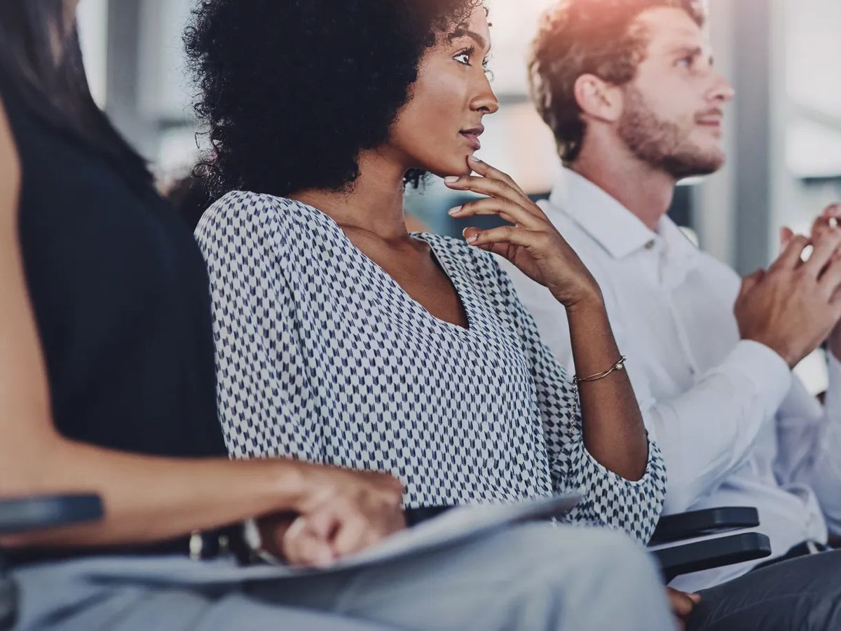 Education, development and seminar with business people at presentation for learning or training. Corporate, event or workshop with man and woman employee group in audience or crowd at office.