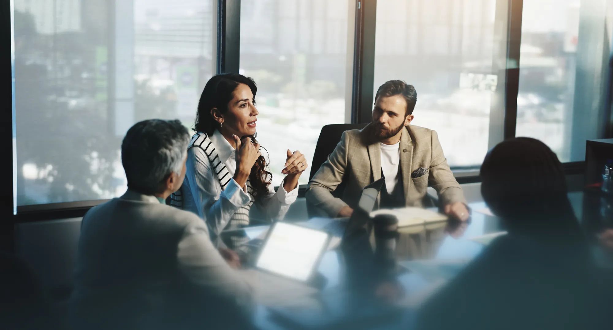 Meeting, woman and collaboration with colleagues, boardroom and discussion for stats, team and company. Corporate, employees and people with info for business, planning and communication for updates.