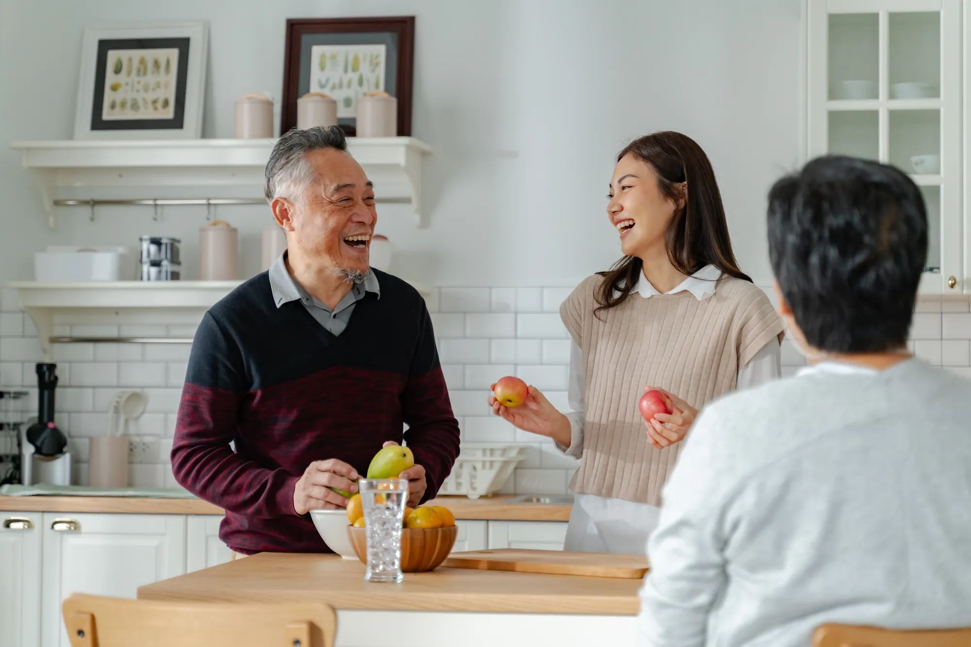 Asian lovely family,young daughter look to old mother and dad cook in kitchen.asian female enjoy spend leisure time senior elderly mom make breakfast on table in house.Activity family relationship 