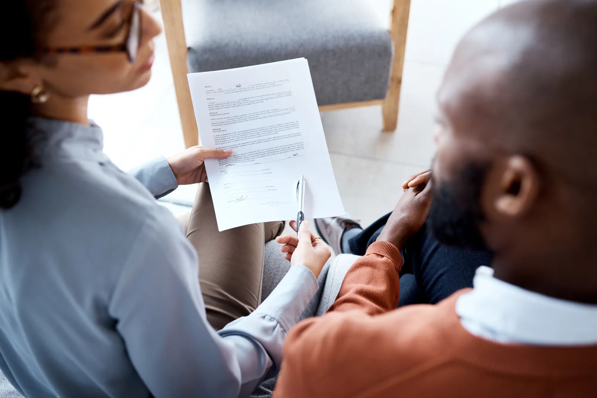 Document, medical agreement and black man with woman sign paperwork, health insurance and legal contract. Communication, doctor in psychology and patient, consultation to explain terms and conditions.
