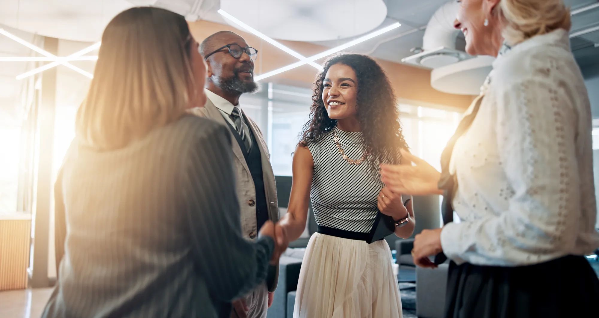 Meeting, handshake and business people in office for partnership, agreement and thank you. Corporate, teamwork and happy men and women shaking hands for collaboration, success and b2b networking.