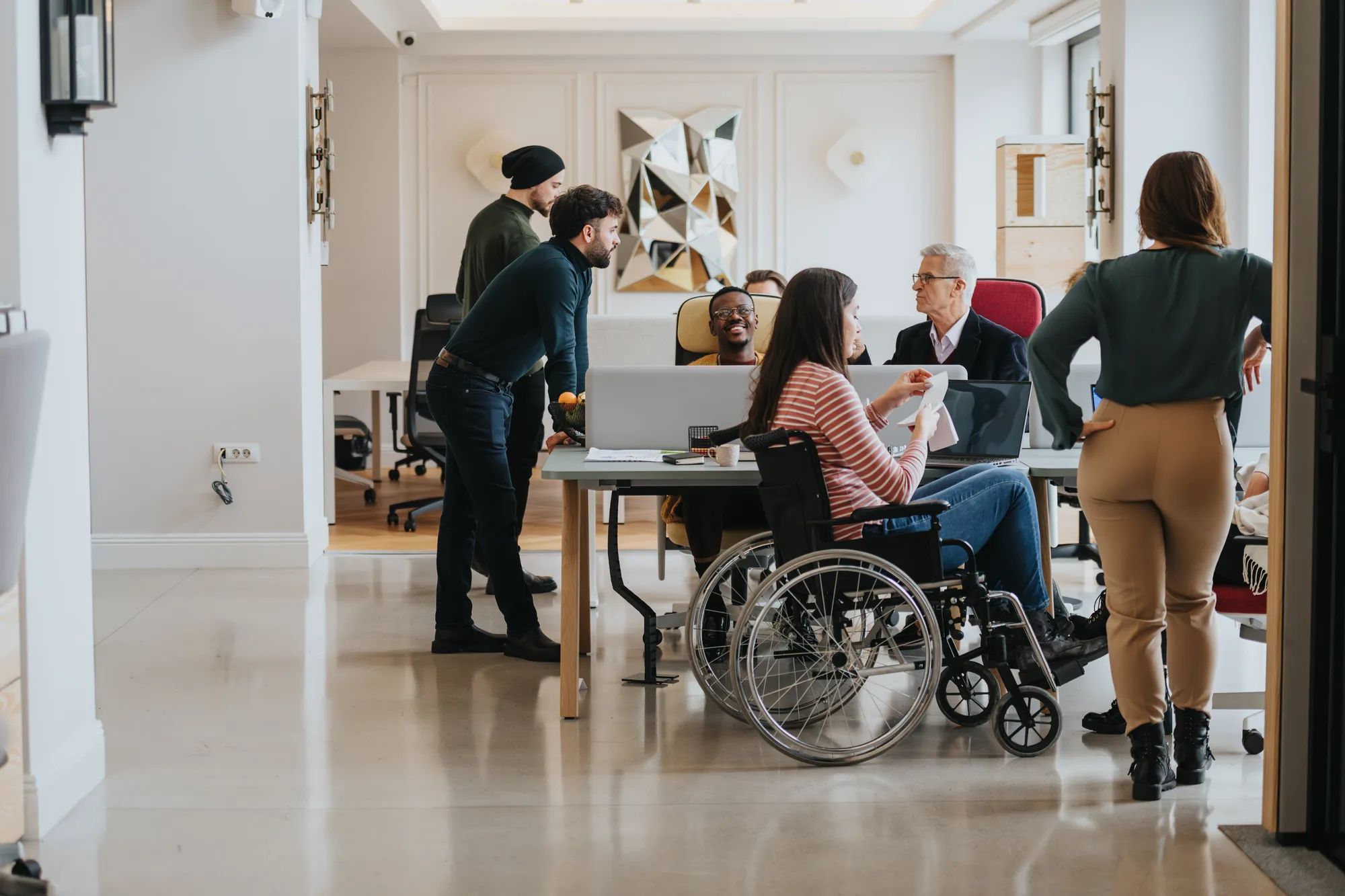 Inclusive business team in a modern office setting engaging in a collaborative discussion.