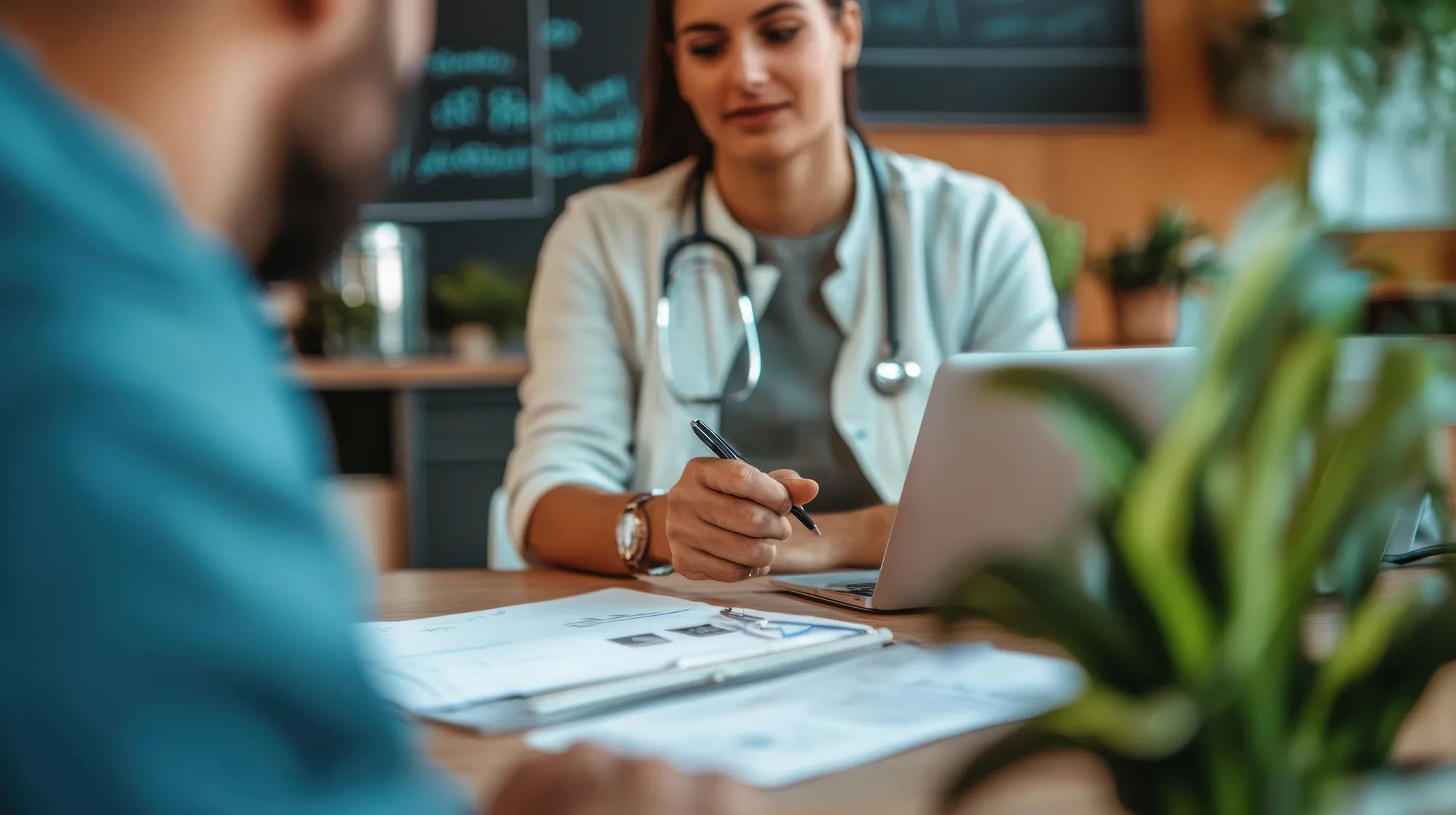 A person discussing pet insurance options with a vet while their dog waits