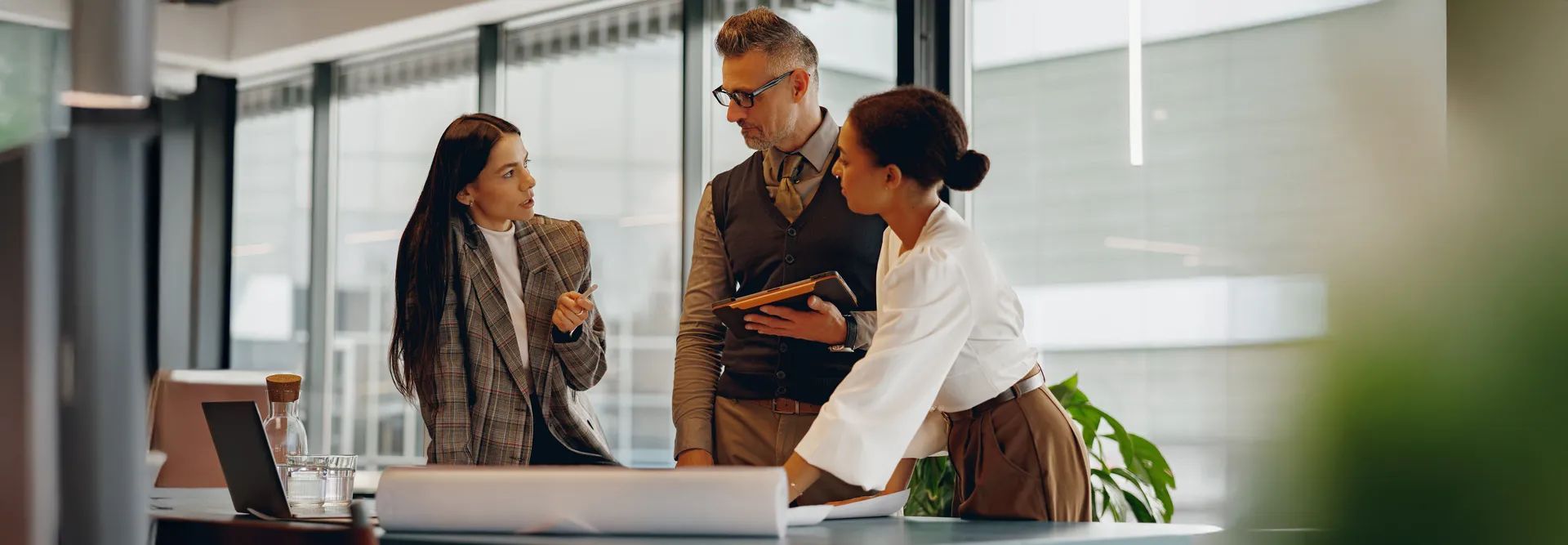 A diverse group of professionals actively participating in discussion and collaboration at a modern workspace