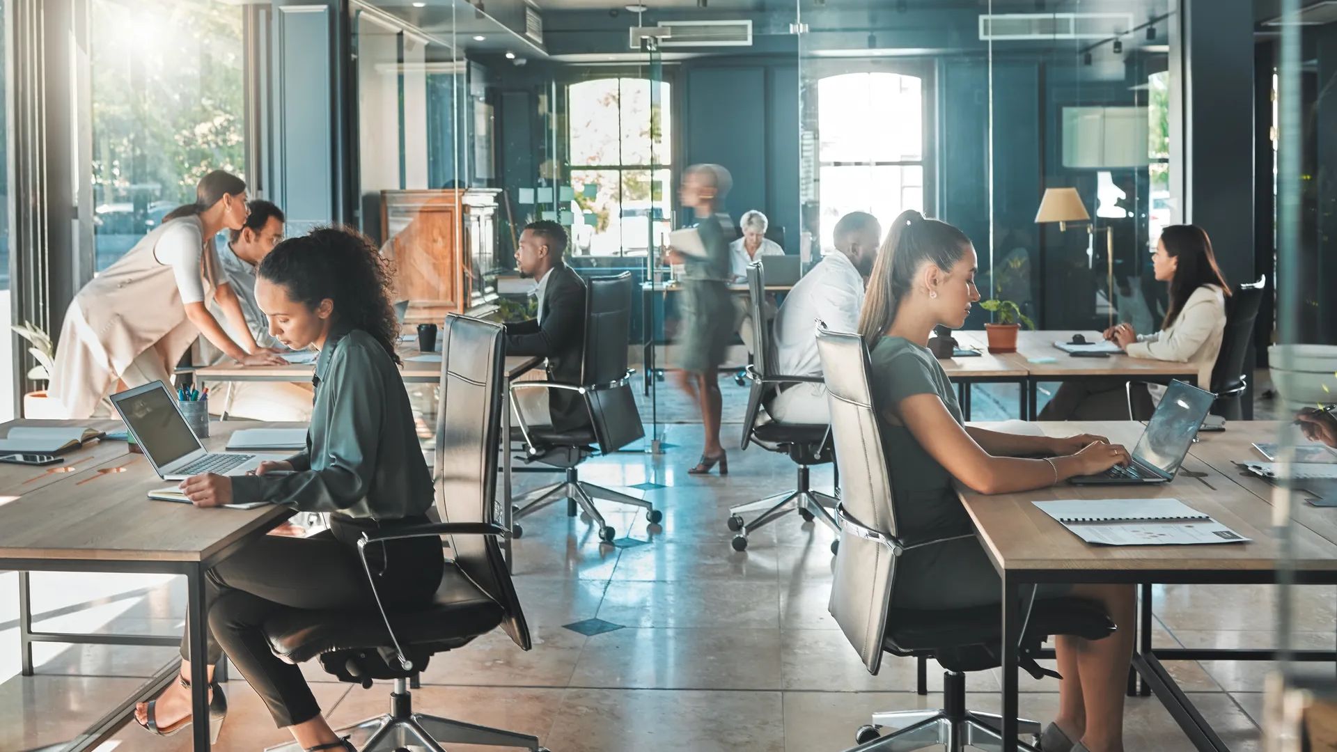 Corporate business people working in busy marketing office space, planning strategy in books and reading email on laptop at work. Businessman, businesswoman and workers at startup advertising company.