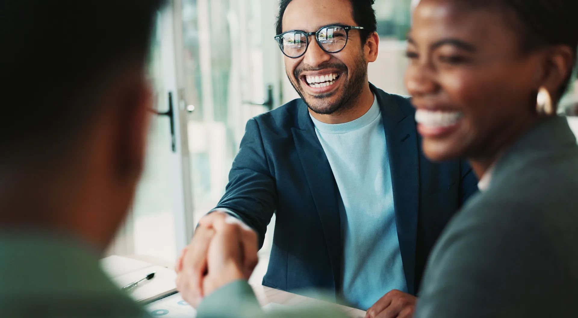 Business, people and handshake with welcome in office for b2b upsell opportunity and contract agreement success. Internal collaboration, happy account manager and shaking hands for client onboarding.