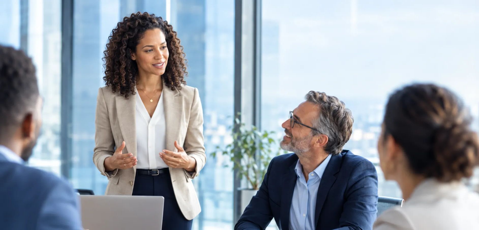 woman presenting to table of people
