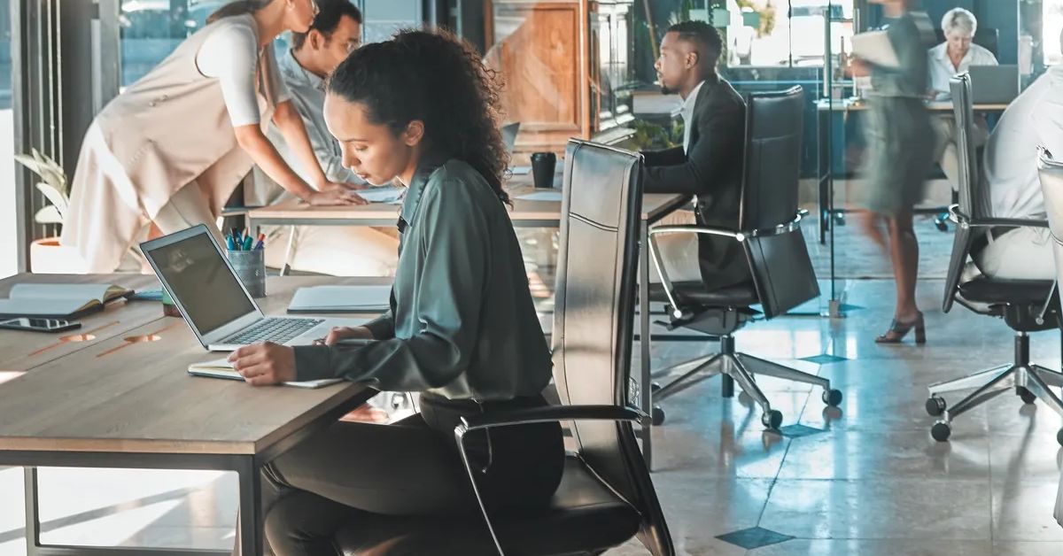 Corporate business people working in busy marketing office space, planning strategy in books and reading email on laptop at work. Businessman, businesswoman and workers at startup advertising company.