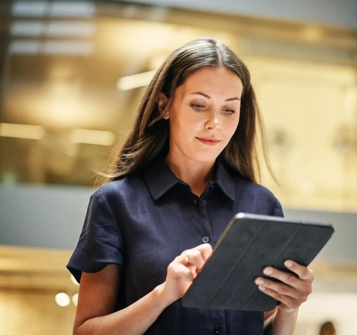 Portrait of a Powerful Female Leader Checking Meeting Briefing on her Tablet and Walking in Busy Corporate Office. Confident Caucasian Team Leader Preparing for a Presentation. Low Angle