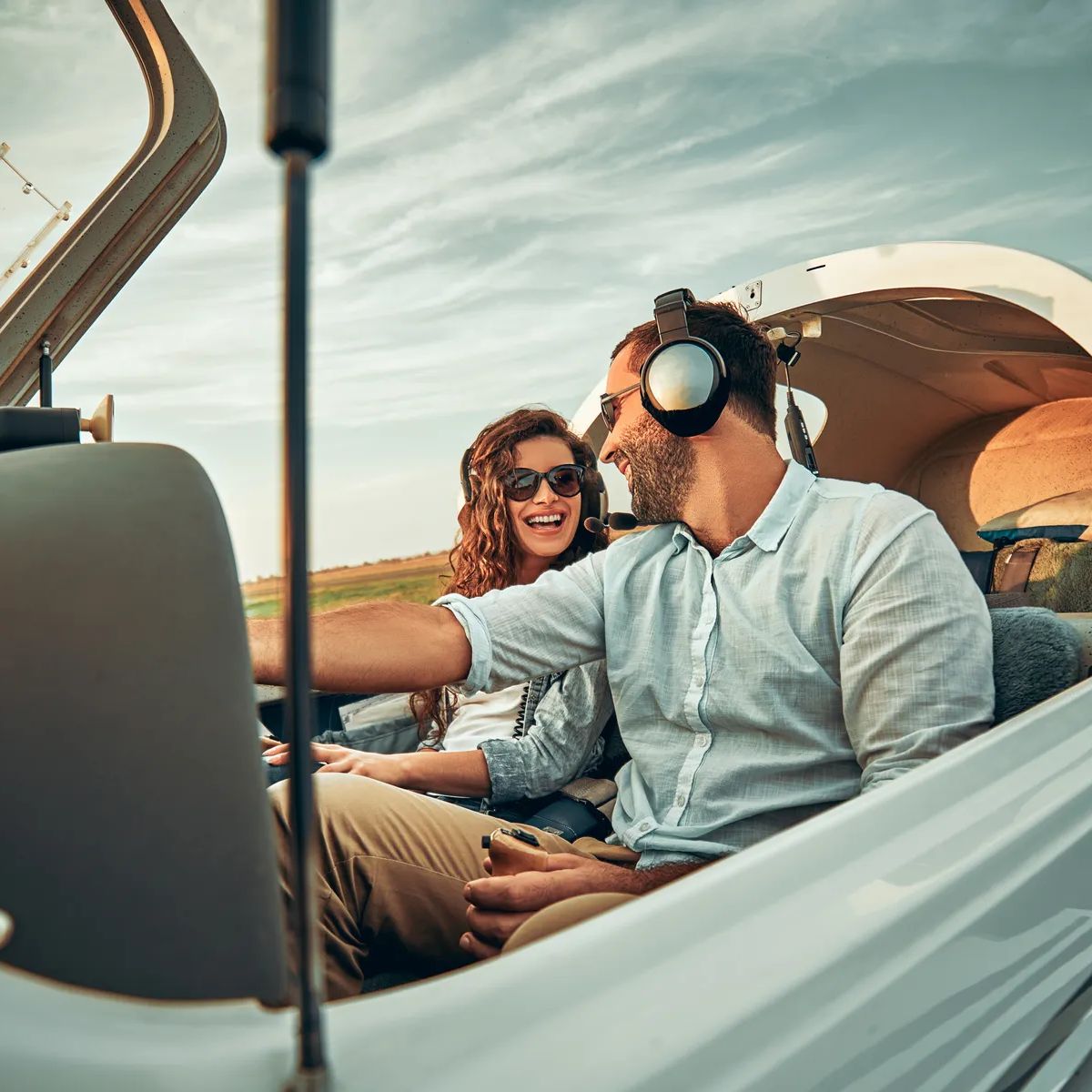 Couple in love in a small private airplane. Boyfriend is training his girlfriend