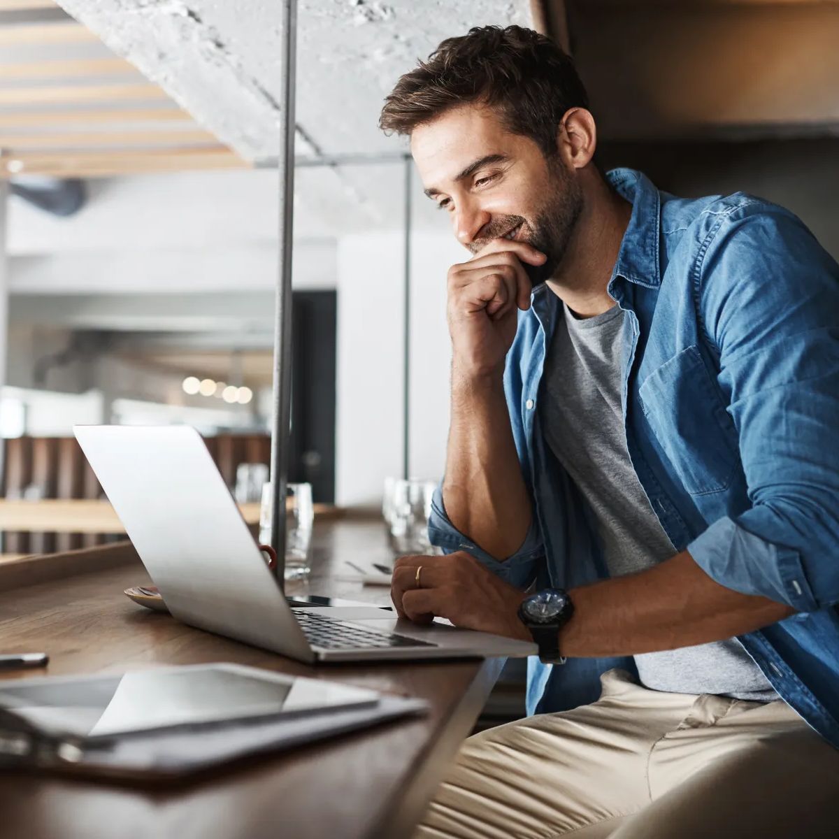 Man in coffee shop, laptop and small business owner, entrepreneur in hospitality management and connectivity. Happy male professional, cafe franchise and wireless connection with digital admin on pc.