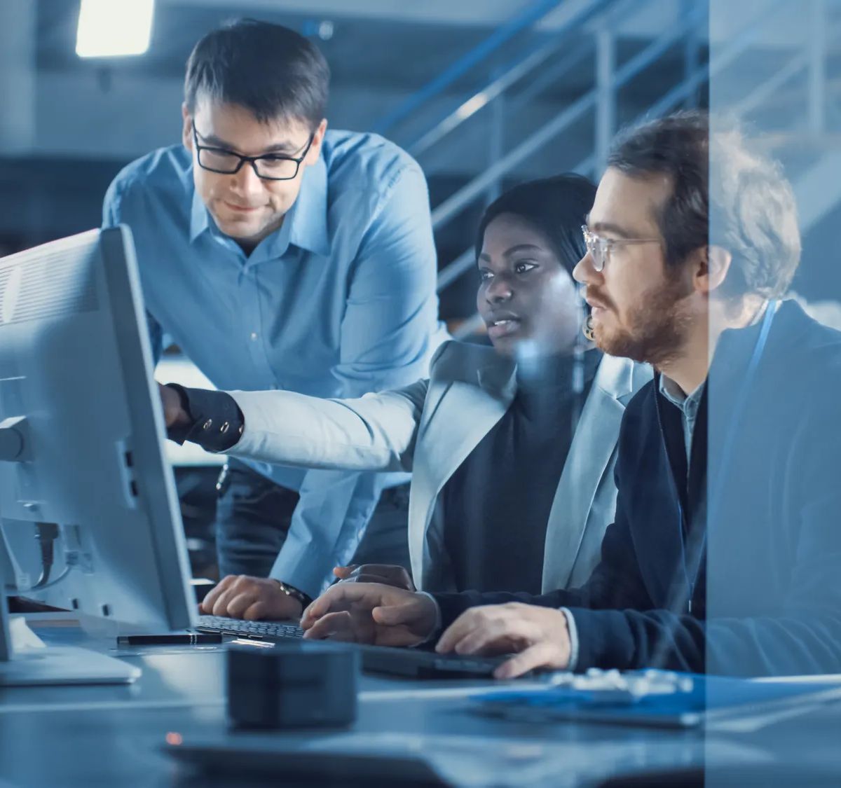 Electronics Development Engineer Working on Computer, Talks with Project Manager, Another Specialist Joins Discussion. Team of Professionals Use CAD Software for the Modern Industrial Engineering Design.