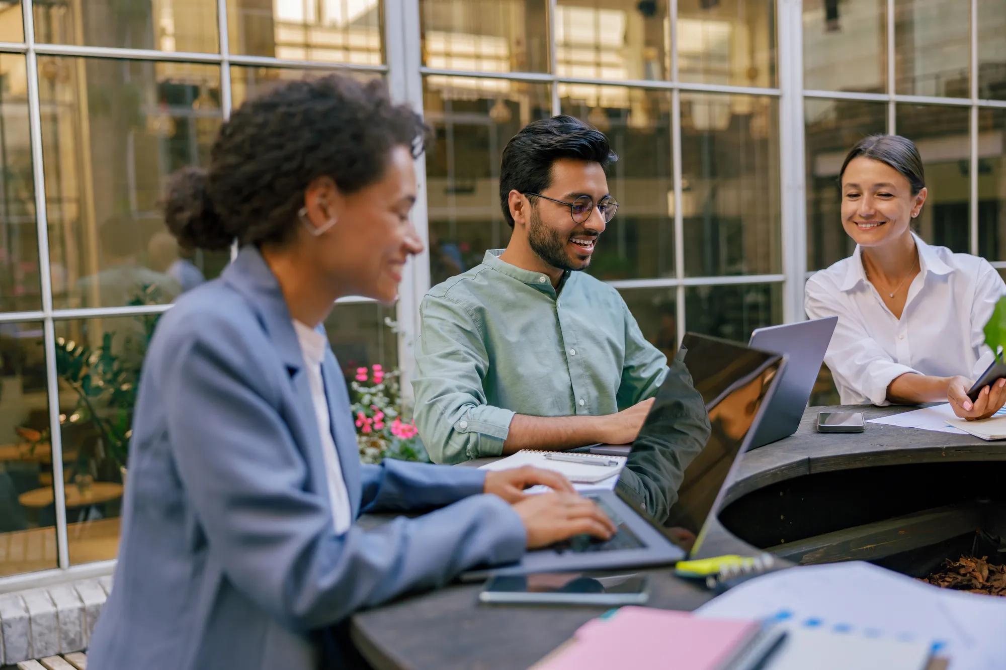 Group of office workers working on the terrace of the office. Teamwork concept . High quality photo