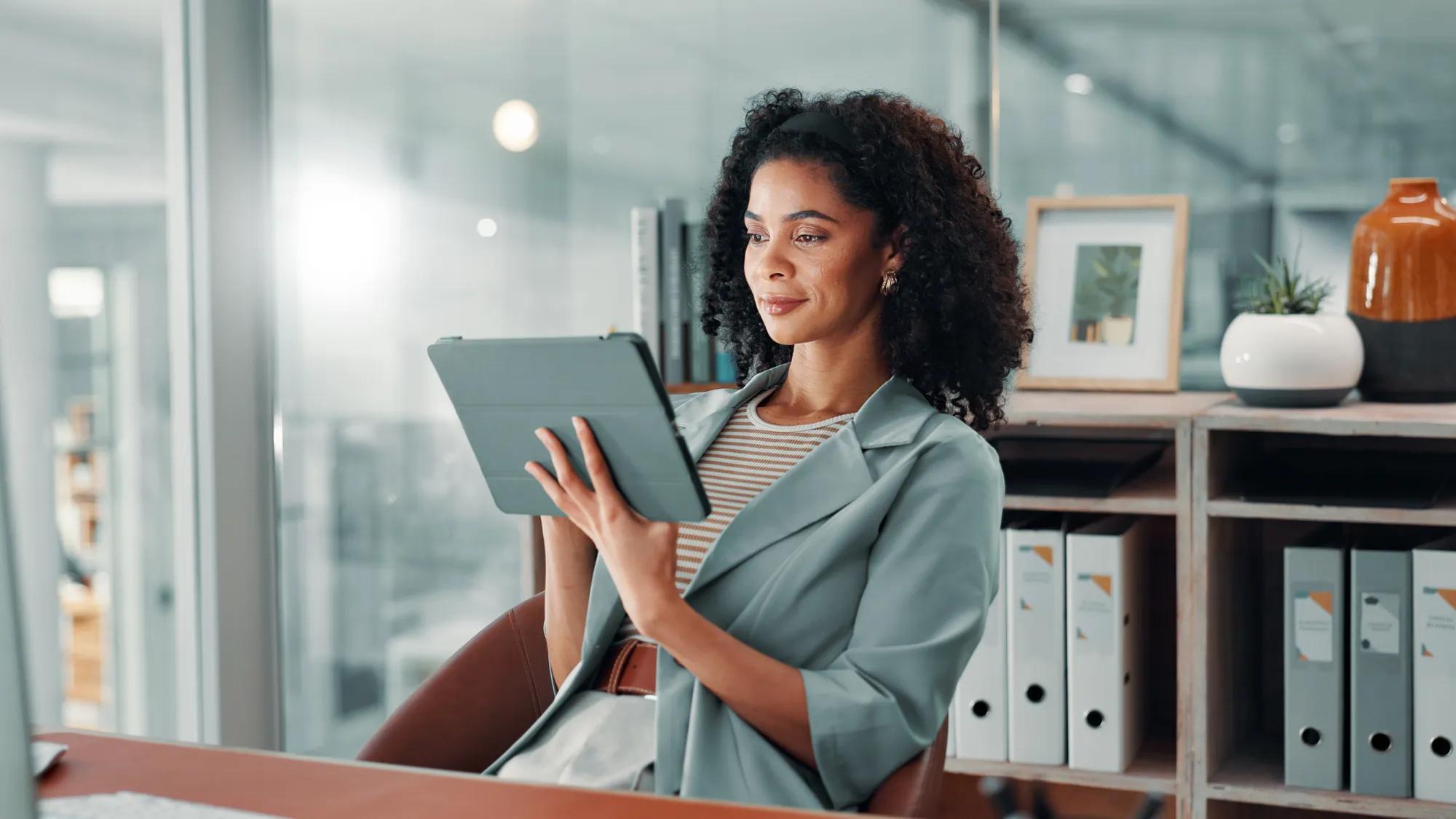 Business, african woman and tablet in office with internet connection for accounting, communication or email. Employee, person and technology for finances, accounts and online payroll review.